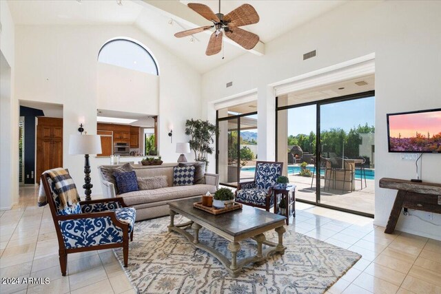 living room featuring ceiling fan, light tile patterned flooring, and high vaulted ceiling