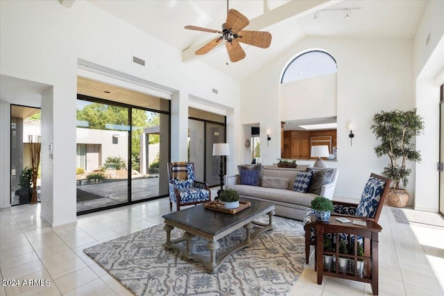 tiled living room with ceiling fan and high vaulted ceiling