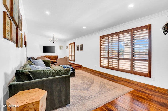 living room featuring ornamental molding, a chandelier, and hardwood / wood-style floors