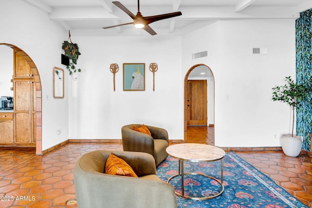 tiled living room with beamed ceiling and ceiling fan