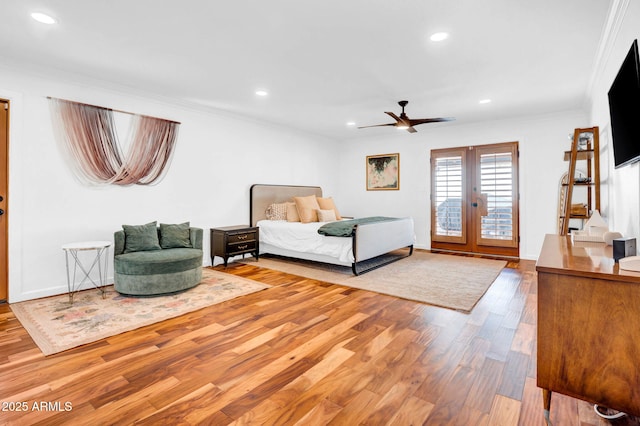 bedroom with hardwood / wood-style flooring, access to outside, ceiling fan, crown molding, and french doors