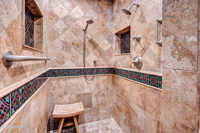 interior details featuring a tile shower