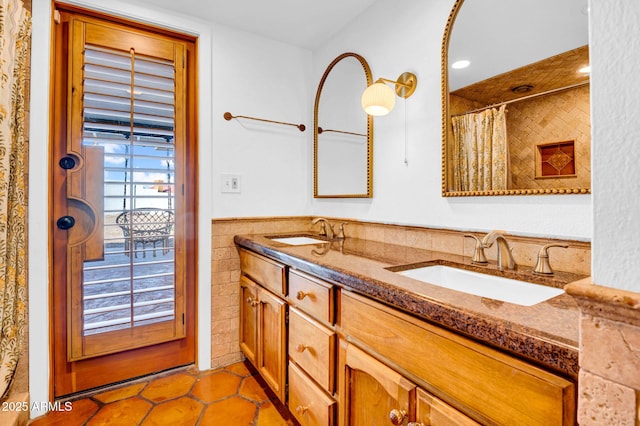 bathroom with tile patterned flooring, vanity, tile walls, and walk in shower