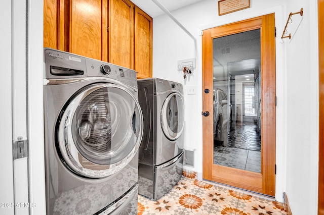 laundry room with cabinets and separate washer and dryer