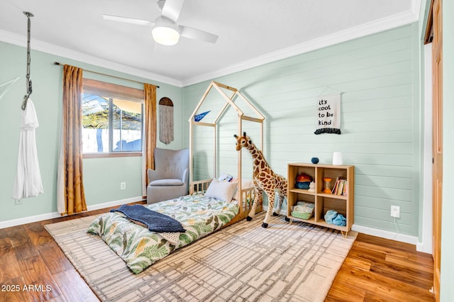 bedroom featuring ceiling fan, ornamental molding, and hardwood / wood-style floors