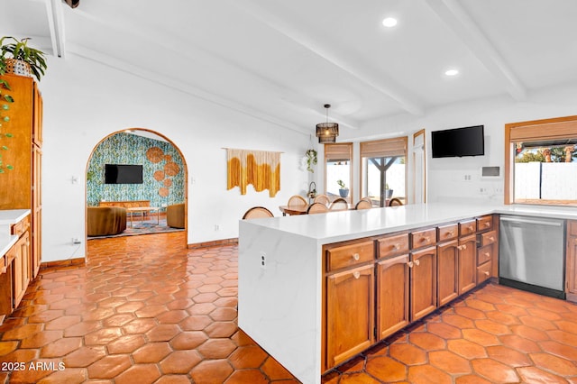 kitchen with hanging light fixtures, lofted ceiling with beams, stainless steel dishwasher, and kitchen peninsula