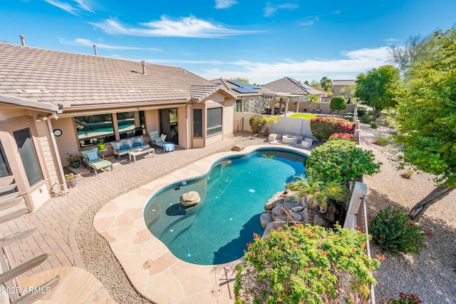 view of swimming pool with a fenced in pool, a patio area, a fenced backyard, and an outdoor living space