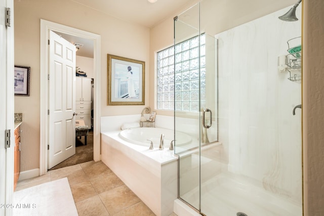 full bathroom featuring a stall shower, vanity, a bath, and tile patterned floors