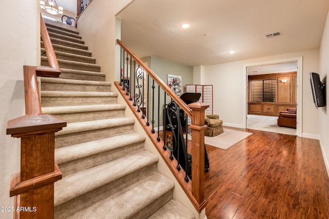 stairway featuring wood-type flooring