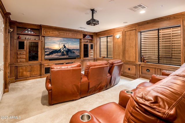 home theater with light carpet, visible vents, and built in features