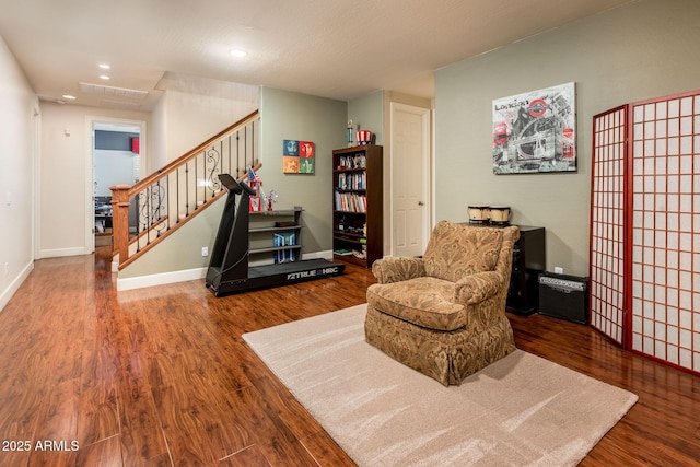 living area with recessed lighting, visible vents, stairway, wood finished floors, and baseboards