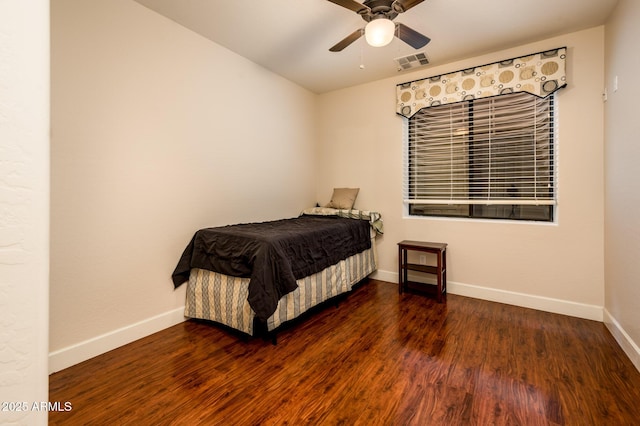 bedroom featuring ceiling fan, dark wood finished floors, visible vents, and baseboards