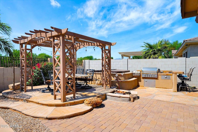 view of patio / terrace with area for grilling, a pergola, and exterior kitchen