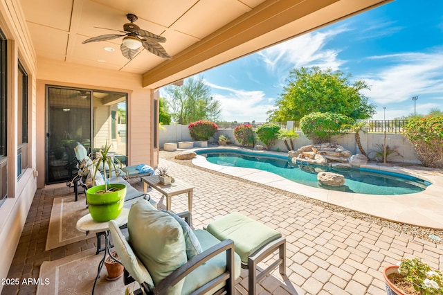 view of swimming pool with ceiling fan, a patio, a fenced in pool, and a fenced backyard