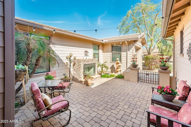 view of patio / terrace with a fireplace with raised hearth