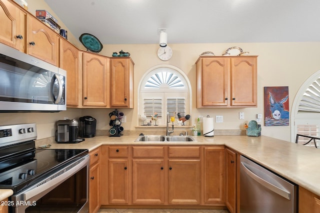 kitchen featuring sink, kitchen peninsula, and appliances with stainless steel finishes