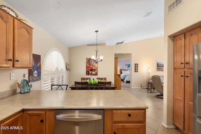 kitchen with lofted ceiling, a chandelier, hanging light fixtures, light tile patterned floors, and stainless steel appliances