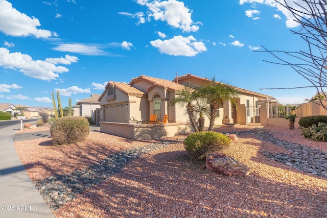 mediterranean / spanish house with a garage