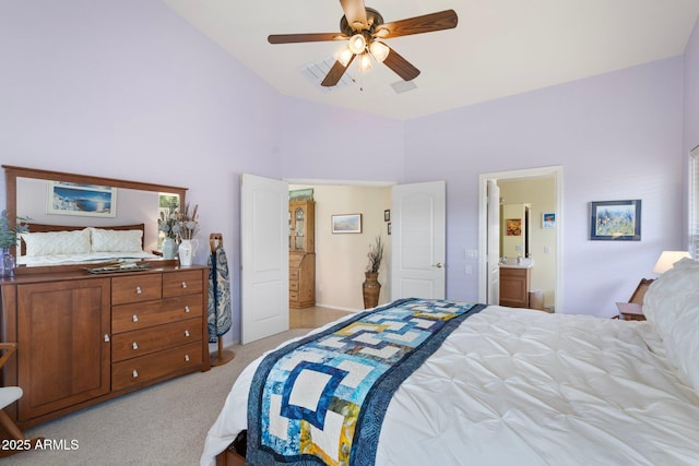 carpeted bedroom with ensuite bathroom, high vaulted ceiling, and ceiling fan