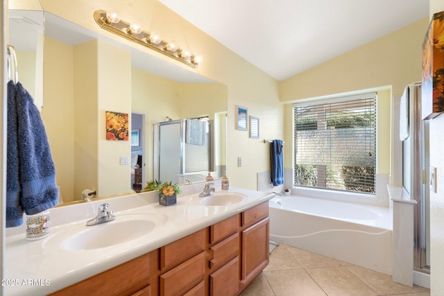 bathroom with tile patterned flooring, vanity, lofted ceiling, and independent shower and bath