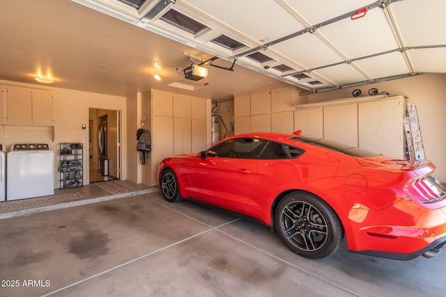 garage with a garage door opener, washing machine and dryer, and water heater