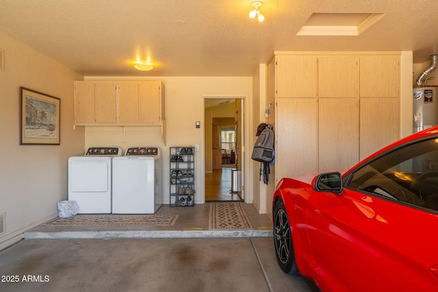 garage with independent washer and dryer and water heater