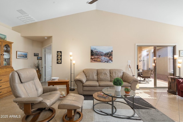 living room featuring light tile patterned floors and high vaulted ceiling