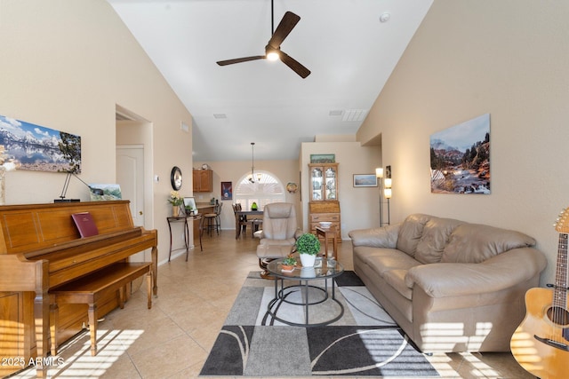 living room featuring ceiling fan, light tile patterned floors, and high vaulted ceiling