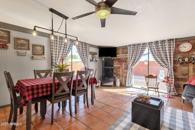 dining space with tile patterned floors and ceiling fan