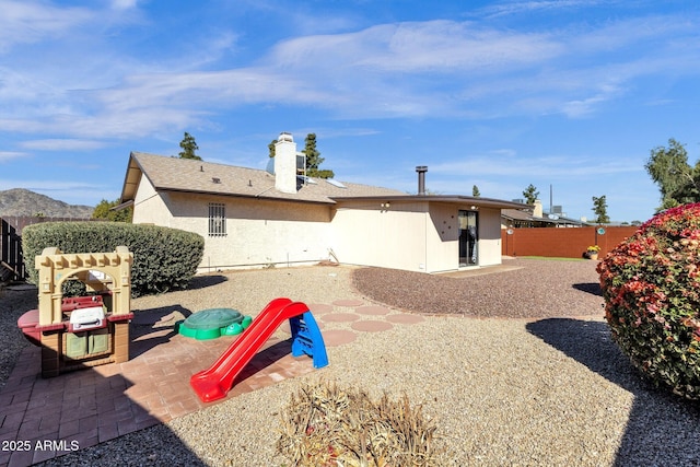 rear view of property featuring a mountain view and a patio area