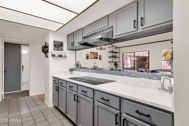 kitchen featuring gray cabinetry, black electric stovetop, and light tile patterned floors