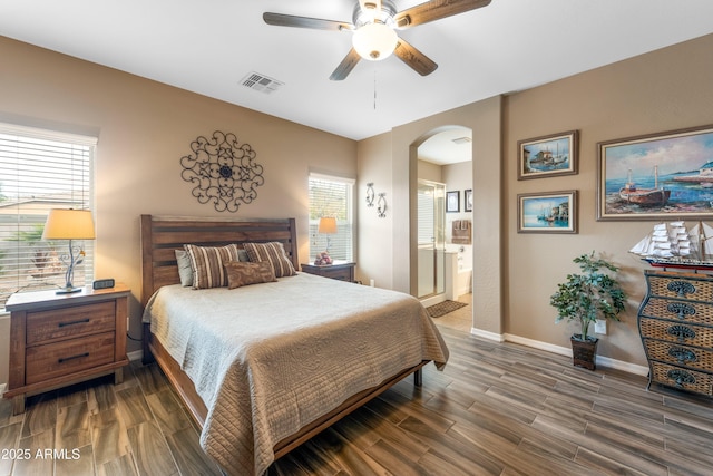 bedroom with connected bathroom, ceiling fan, and multiple windows