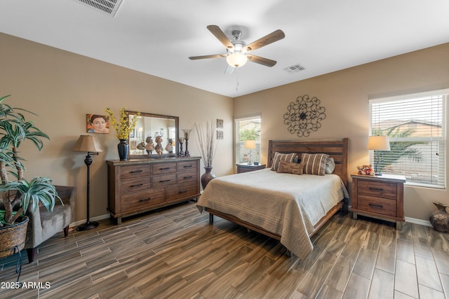 bedroom with ceiling fan and multiple windows