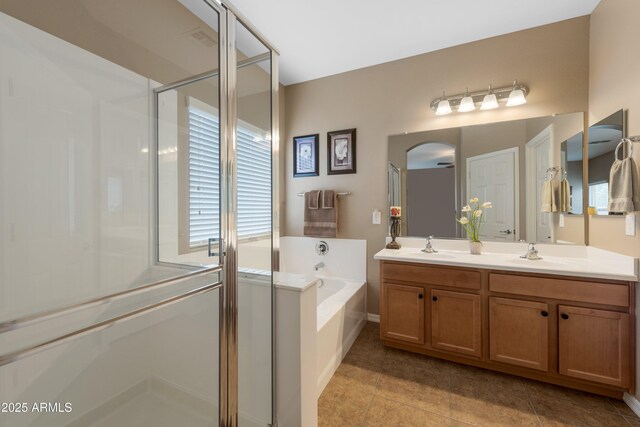 bathroom featuring tile patterned floors, vanity, and plus walk in shower