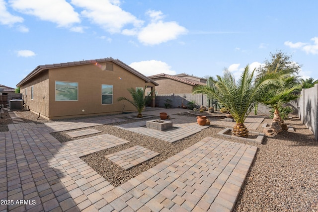 back of house featuring a patio and an outdoor fire pit