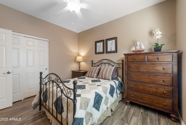 bedroom featuring ceiling fan, a closet, and dark wood-type flooring