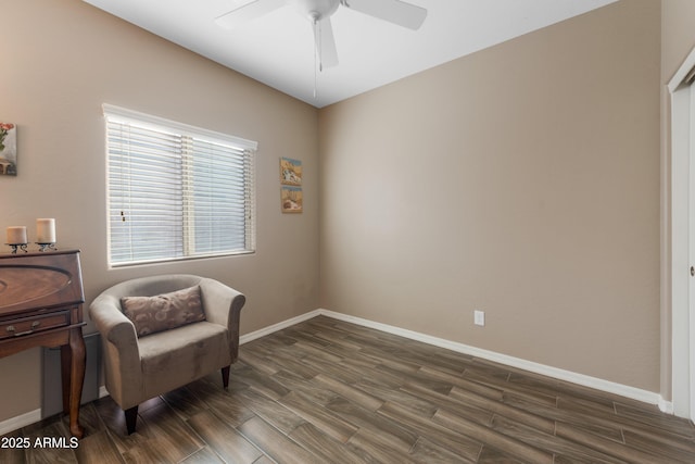 living area featuring ceiling fan and dark wood-type flooring