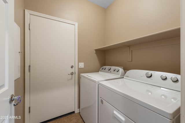 laundry room featuring washing machine and clothes dryer and light tile patterned flooring