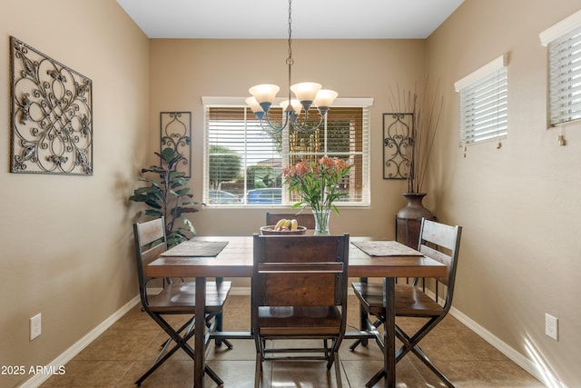 dining area featuring tile patterned flooring and an inviting chandelier