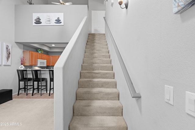 stairs featuring carpet and recessed lighting