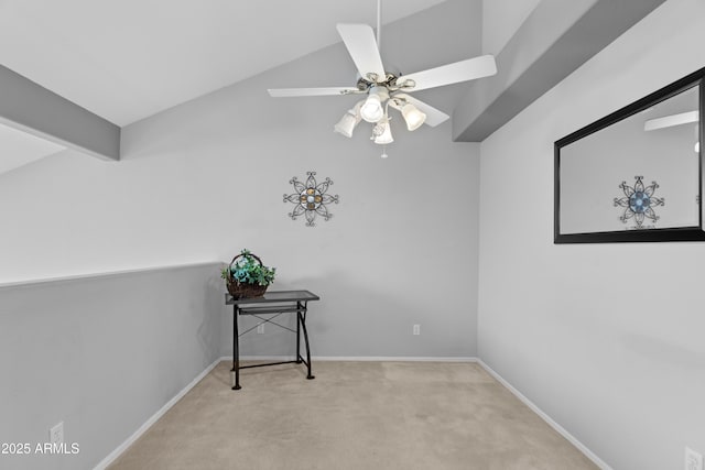 interior space with carpet flooring, baseboards, and vaulted ceiling