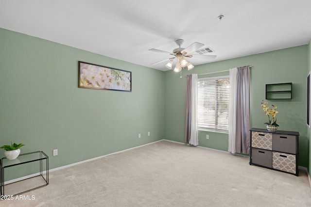 unfurnished bedroom featuring carpet floors, baseboards, and a ceiling fan