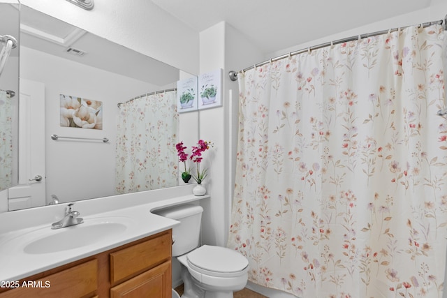 bathroom with vanity, toilet, and curtained shower