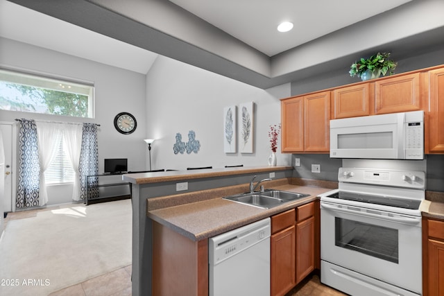kitchen featuring white appliances, a sink, a peninsula, light carpet, and open floor plan