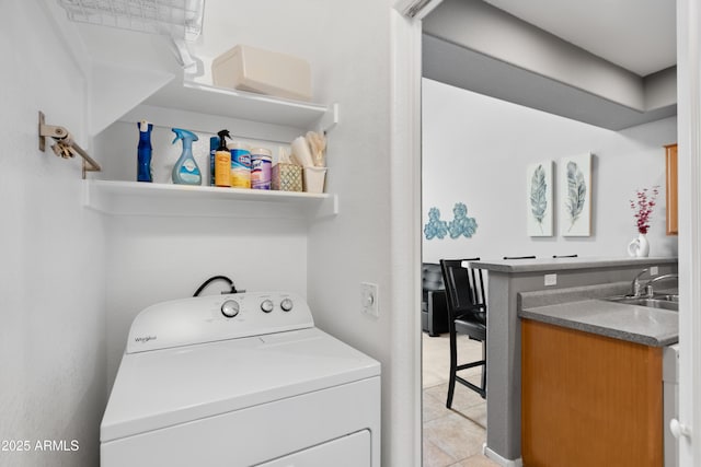 washroom with washer / dryer and light tile patterned floors