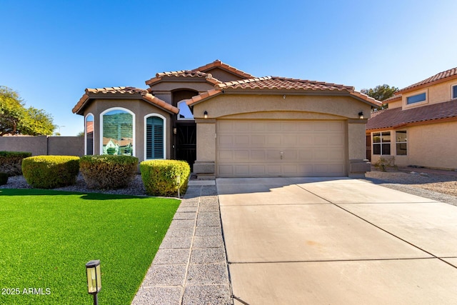 mediterranean / spanish-style house featuring a front lawn and a garage