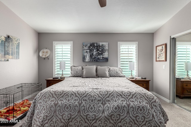 carpeted bedroom featuring ceiling fan and multiple windows