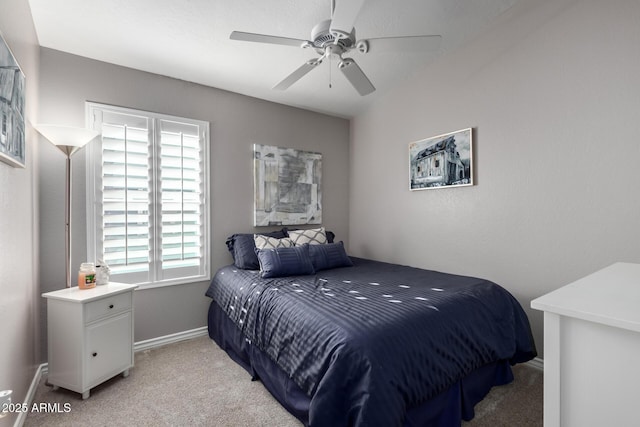 bedroom featuring multiple windows, ceiling fan, and light colored carpet