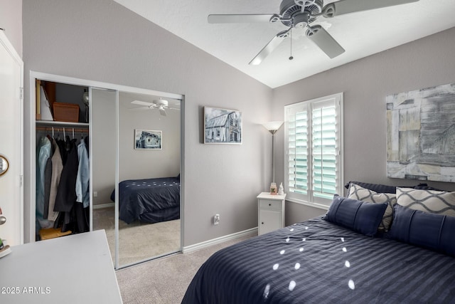 carpeted bedroom with lofted ceiling, ceiling fan, and a closet