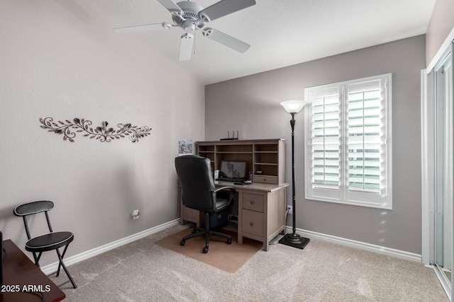 office featuring ceiling fan, vaulted ceiling, and light carpet